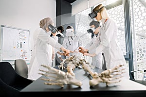 Group of young people of different sex, race, in medical clothes, medical students, scientists, archeologists, study the