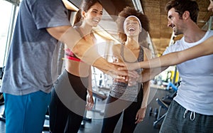Group of young people doing exercises in gym