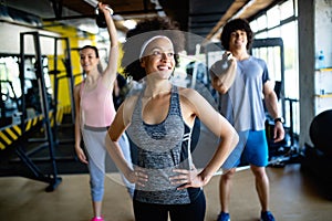 Group of young people doing exercises in gym