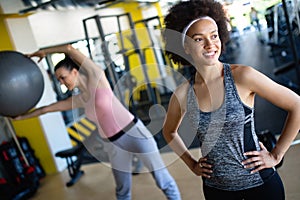 Group of young people doing exercises in gym