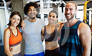 Group of young people doing exercises in gym