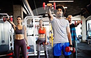 Group of young people doing exercises in gym