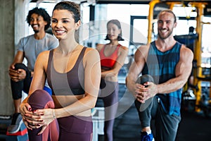 Group of young people doing exercises in gym