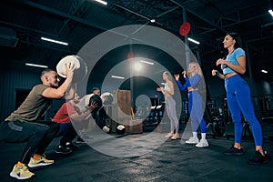 Group of young people doing sports, workout at sport gym, indoors. Sport, active lifestyle, health, youth concept