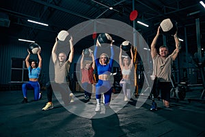 Group of young people doing sports, workout at sport gym, indoors. Sport, active lifestyle, health, youth concept