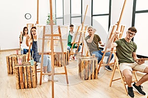 Group of young people drawing at art studio annoyed and frustrated shouting with anger, yelling crazy with anger and hand raised