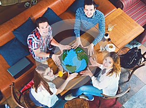 Group of young people with a drawing of a planet Earth