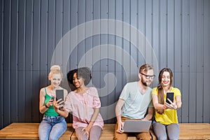 Group of young people with gadgets indoors