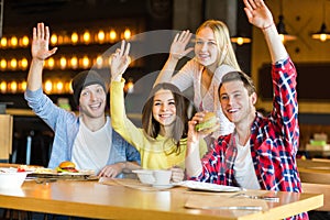 Group of young people having fun in cafe