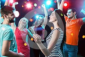 Group of young people having fun dancing at party