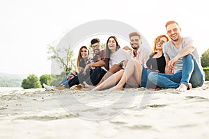 Group of young people having fun outdoors on the beach