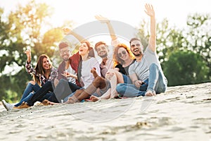 Group of young people having fun outdoors on the beach photo