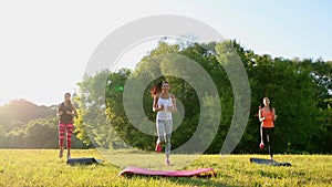 Group of young people having kick boxing training , outdoor