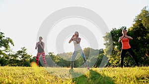Group of young people having kick boxing training , outdoor