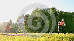 Group of young people having kick boxing training , outdoor