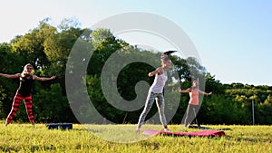 Group of young people having kick boxing training , outdoor