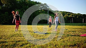 Group of young people having kick boxing training , outdoor