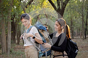 Group of young people hiking trough forest.