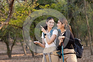 Group of young people hiking trough forest.Outdoors nature concept.