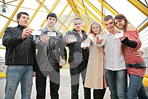 Group of young people hold blank cards