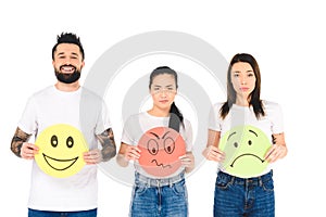 group of young people holding colored cards with angry, sad and happy face expressions isolated