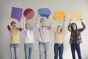 Group of young people holding empty speech bubbles as if expressing their opinions