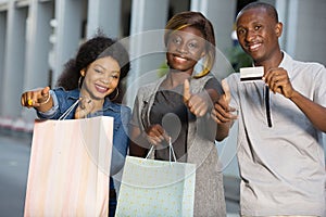 Group of young people holding shopping bags outdoors