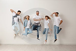 Group of young people in jeans jumping