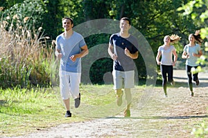 group young people jogging in park
