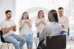 Group of young people learning sign language