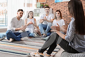 Group of young people learning sign language