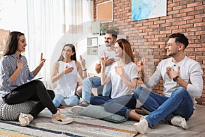 Group of young people learning sign language