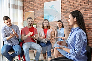 Group of young people learning sign language