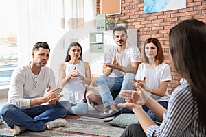 Group of young people learning sign language