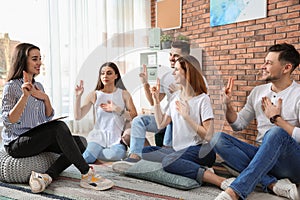 Group of young people learning sign language