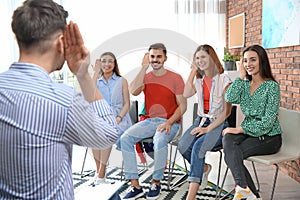 Group of young people learning sign language
