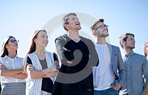 Group of young people looking up at a copy of the space