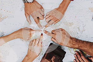 Group of Young People Pointing on Place on Map