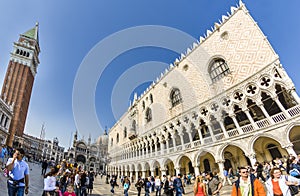 group of young people pose in front of san Marco church basilica at San Marco square in Venice, Italy