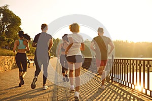 A group of young people are running in the park.