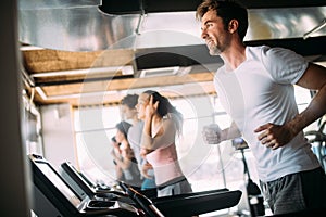 Group of young people running on treadmill in gym