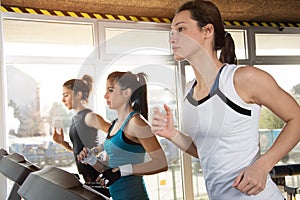 Group of young people running on treadmill in gym