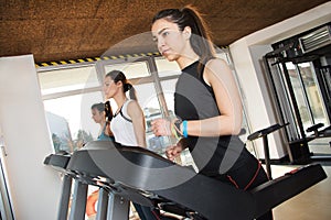 Group of young people running on treadmill in gym