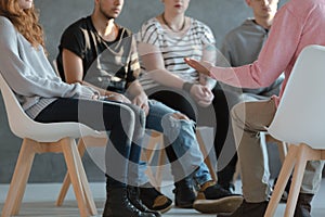 Group of young people sitting in a circle and talking to a psych