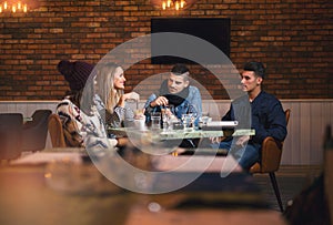 Group of young people sitting in a coffee shop