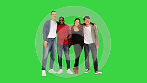 Group of young people smiling and laughing in front of camera, thumbs up on a Green Screen, Chroma Key.