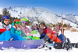 Group of young people with snowboards and goggles