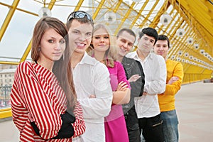 Group of young people stand on footbridge