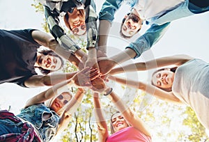 Group of young people standing in a circle, outdoors