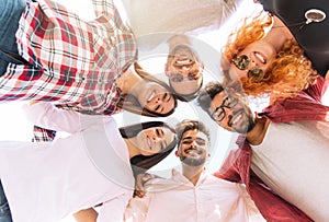 Group of young people standing in a circle, outdoors